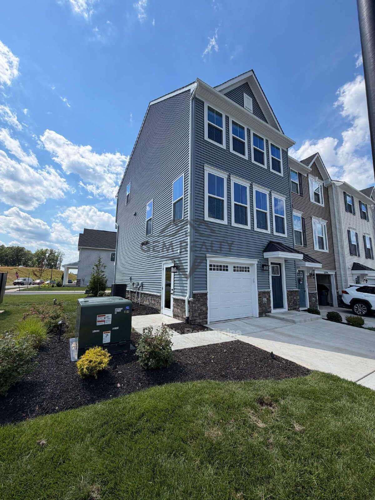 Welcome to Courthouse Commons Townhomes, where you can Rent a brand-new 3 BR 2.5 BA end unit townhome with a one-car garage and a spacious, open-concept floor plan designed for modern living. property image
