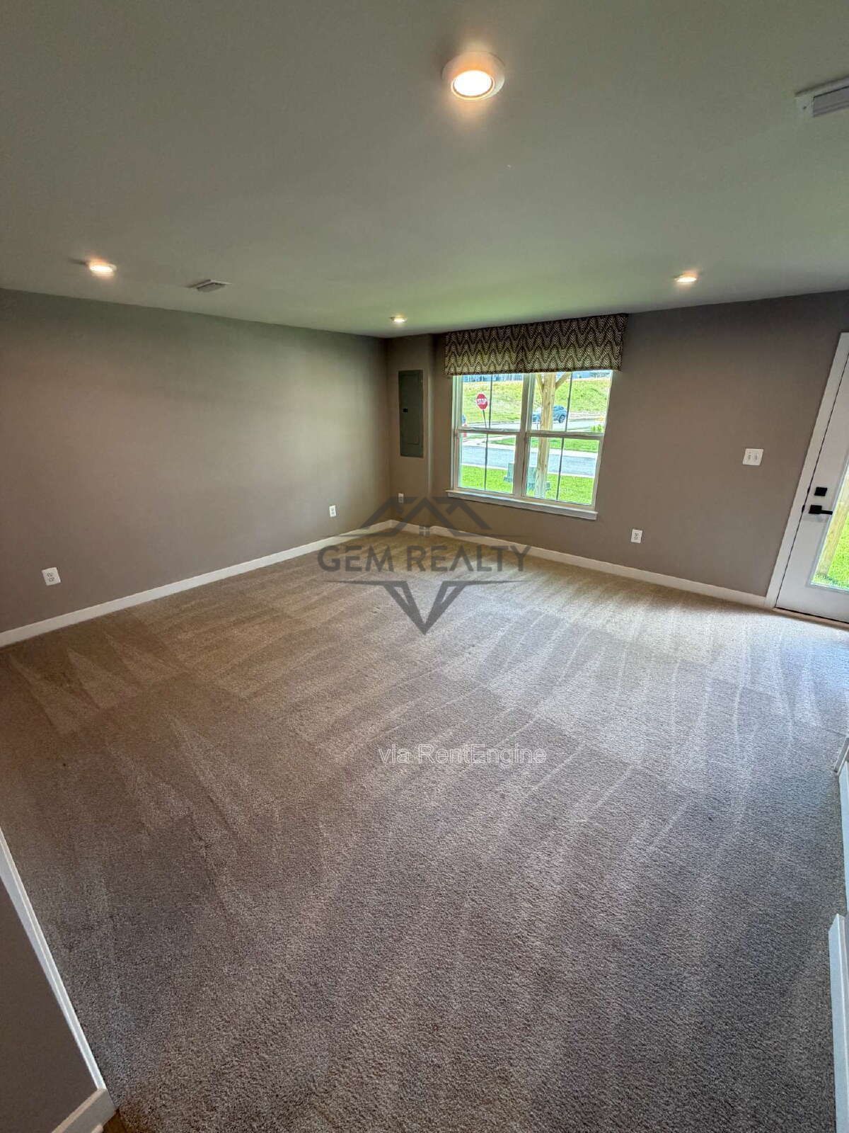 Welcome to Courthouse Commons Townhomes, where you can Rent a brand-new 3 BR 2.5 BA end unit townhome with a one-car garage and a spacious, open-concept floor plan designed for modern living. property image