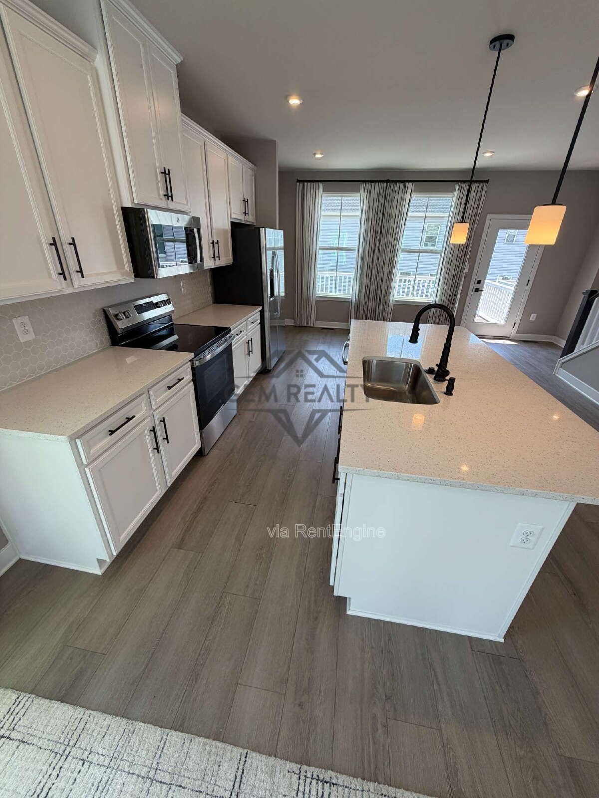Welcome to Courthouse Commons Townhomes, where you can Rent a brand-new 3 BR 2.5 BA end unit townhome with a one-car garage and a spacious, open-concept floor plan designed for modern living. property image