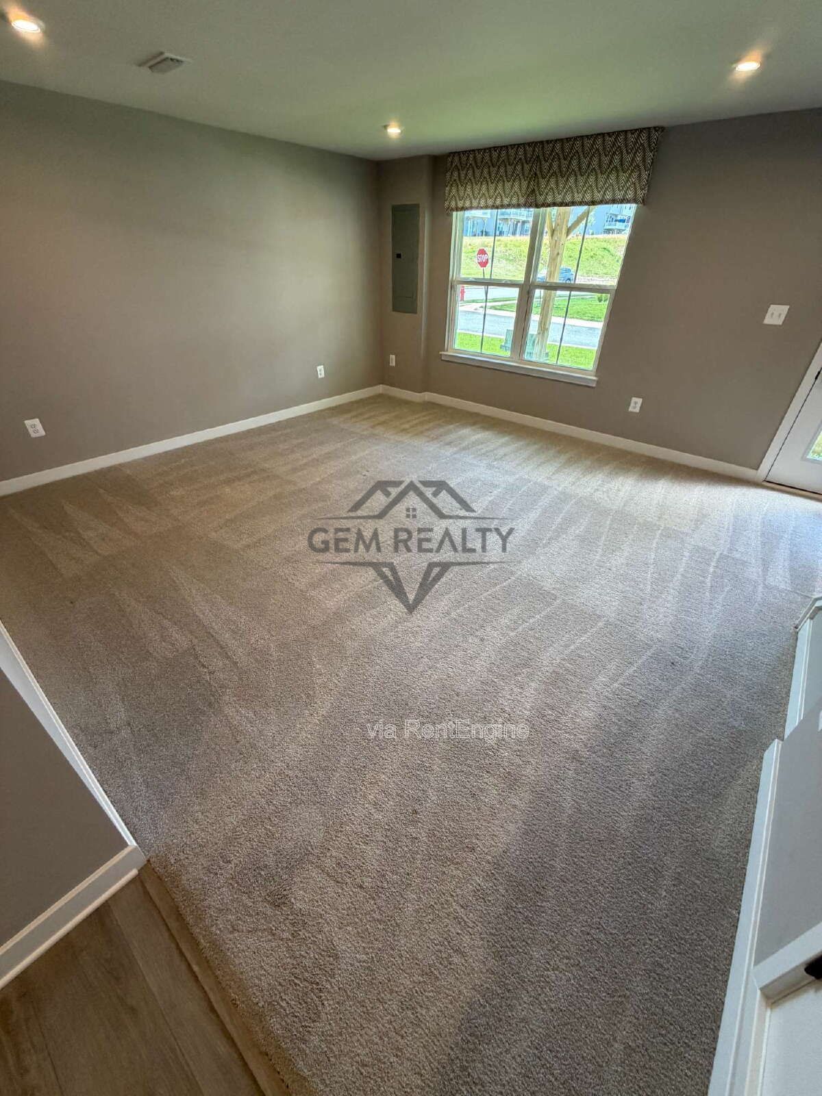 Welcome to Courthouse Commons Townhomes, where you can Rent a brand-new 3 BR 2.5 BA end unit townhome with a one-car garage and a spacious, open-concept floor plan designed for modern living. property image