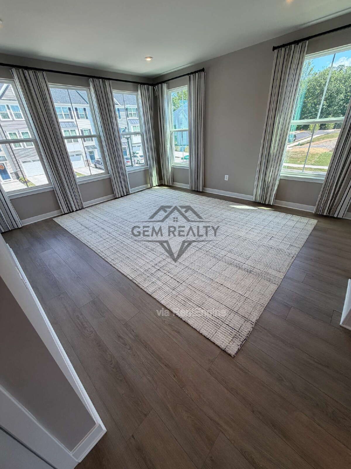 Welcome to Courthouse Commons Townhomes, where you can Rent a brand-new 3 BR 2.5 BA end unit townhome with a one-car garage and a spacious, open-concept floor plan designed for modern living. property image
