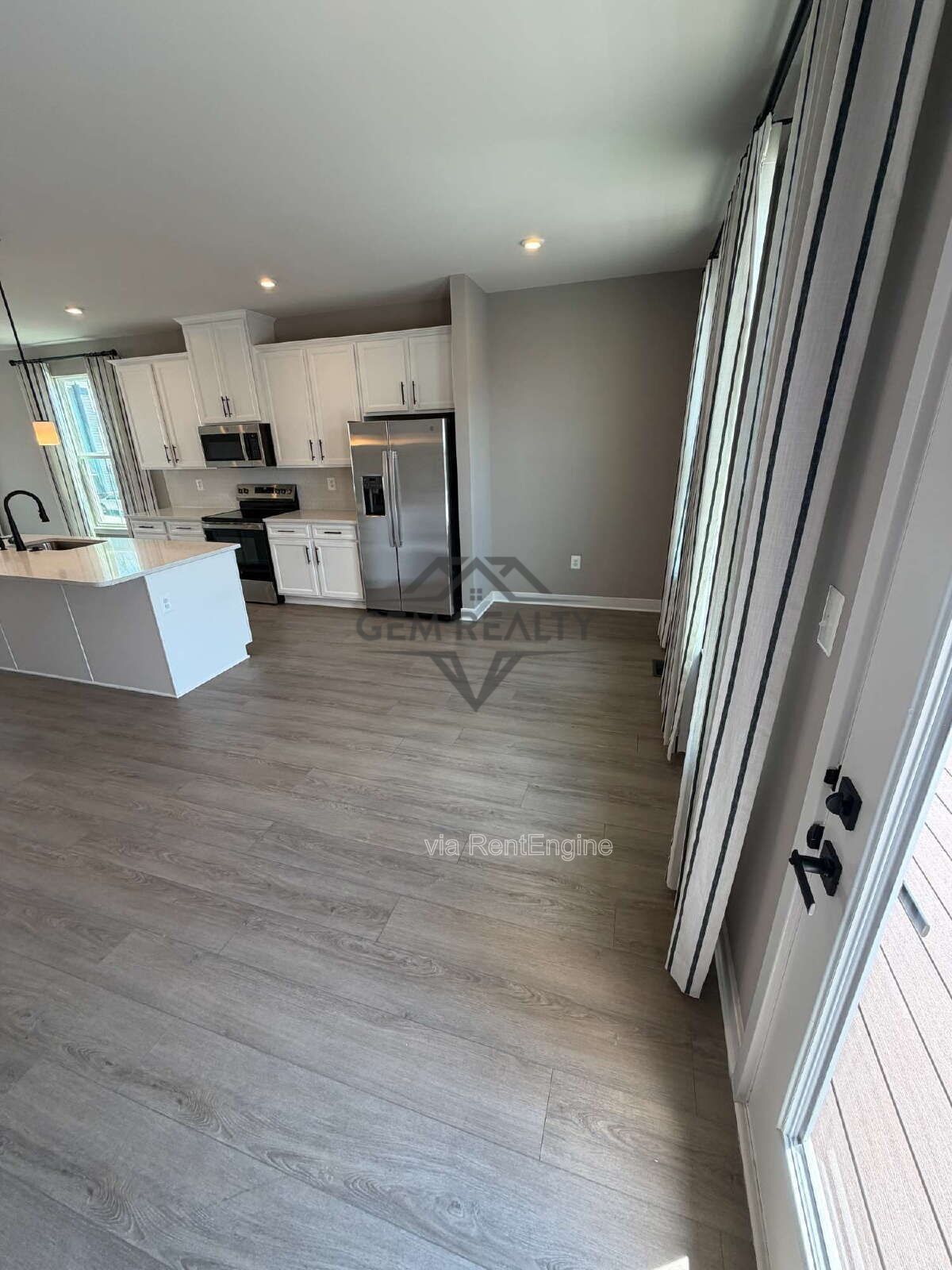 Welcome to Courthouse Commons Townhomes, where you can Rent a brand-new 3 BR 2.5 BA end unit townhome with a one-car garage and a spacious, open-concept floor plan designed for modern living. property image