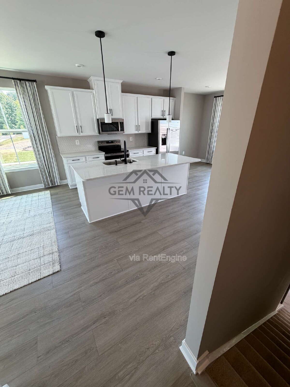Welcome to Courthouse Commons Townhomes, where you can Rent a brand-new 3 BR 2.5 BA end unit townhome with a one-car garage and a spacious, open-concept floor plan designed for modern living. property image