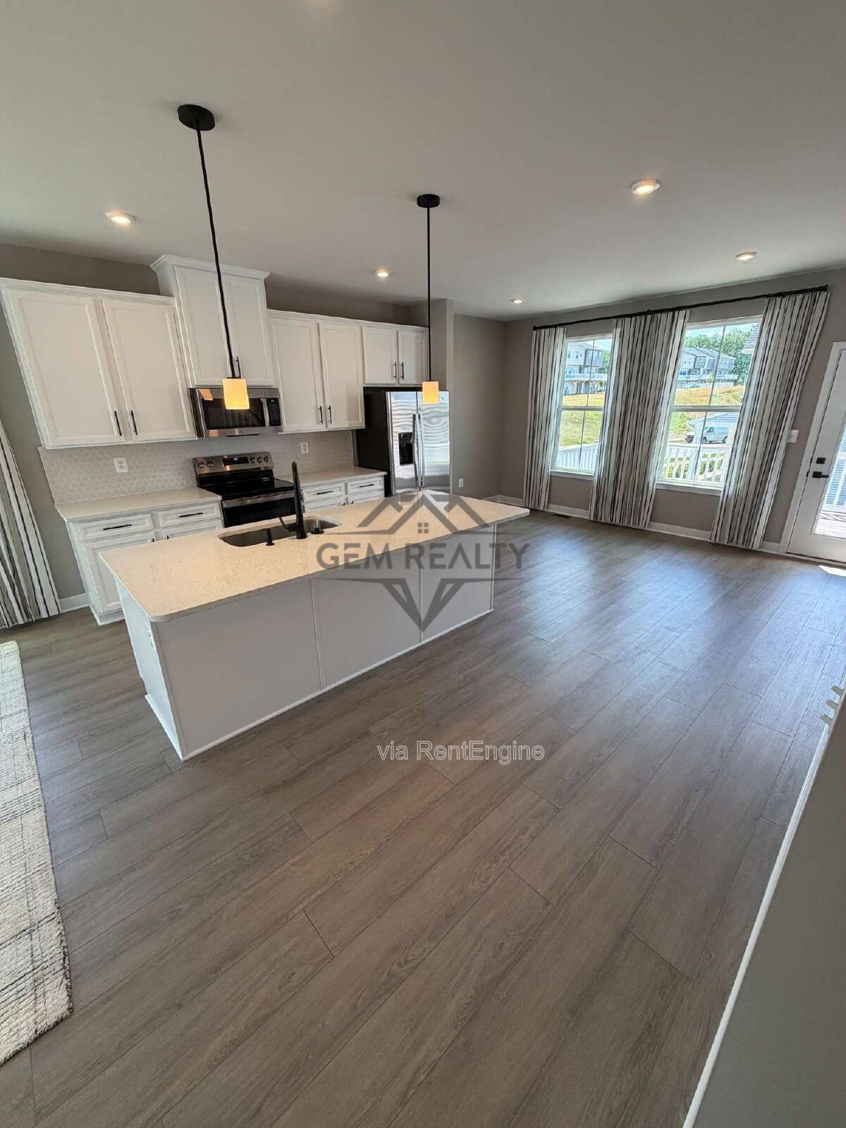 Welcome to Courthouse Commons Townhomes, where you can Rent a brand-new 3 BR 2.5 BA end unit townhome with a one-car garage and a spacious, open-concept floor plan designed for modern living. property image