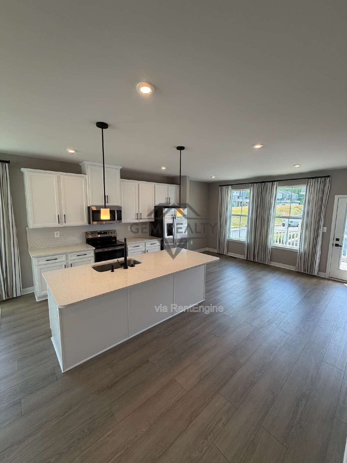 Welcome to Courthouse Commons Townhomes, where you can Rent a brand-new 3 BR 2.5 BA end unit townhome with a one-car garage and a spacious, open-concept floor plan designed for modern living. property image