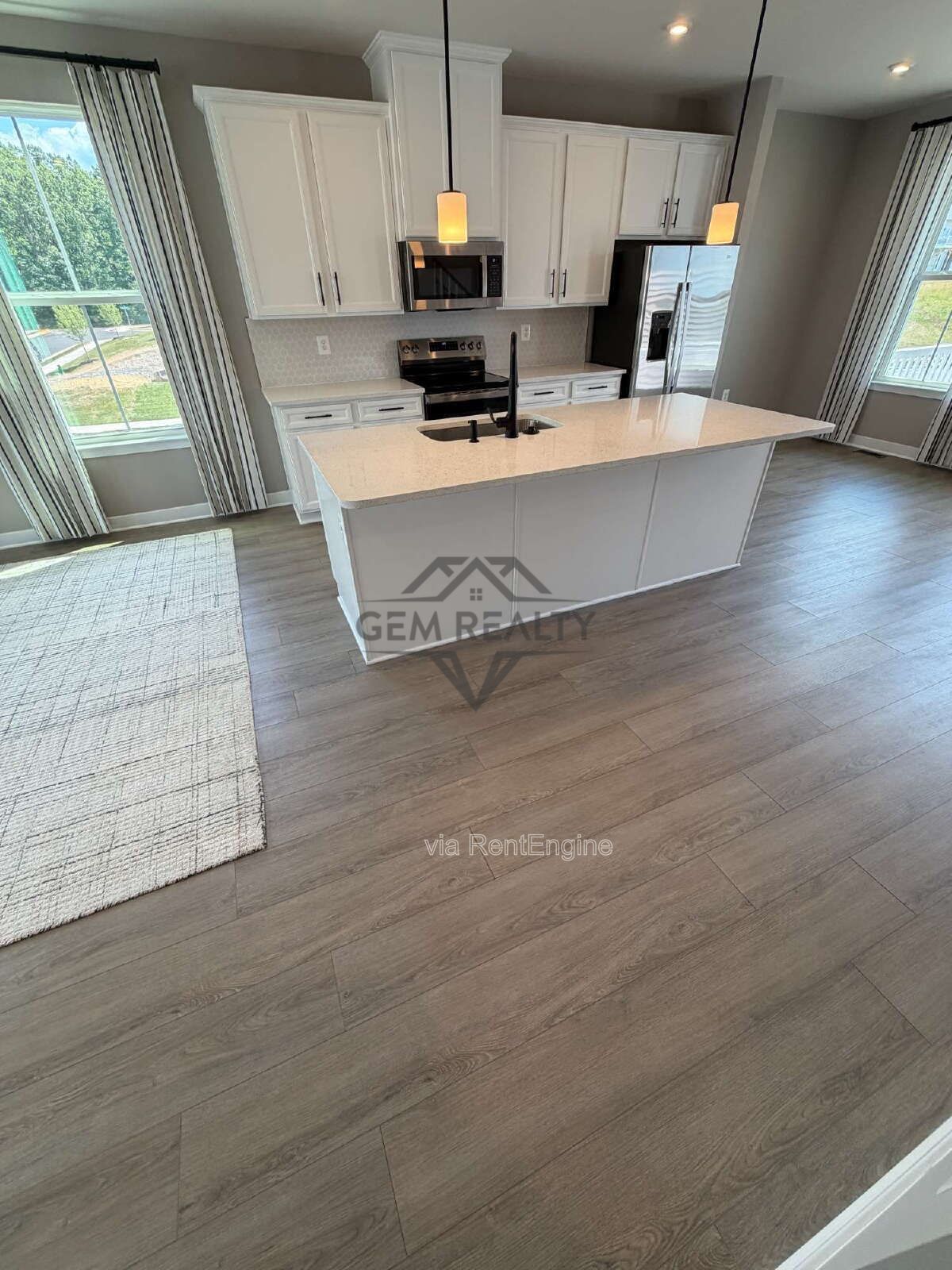Welcome to Courthouse Commons Townhomes, where you can Rent a brand-new 3 BR 2.5 BA end unit townhome with a one-car garage and a spacious, open-concept floor plan designed for modern living. property image