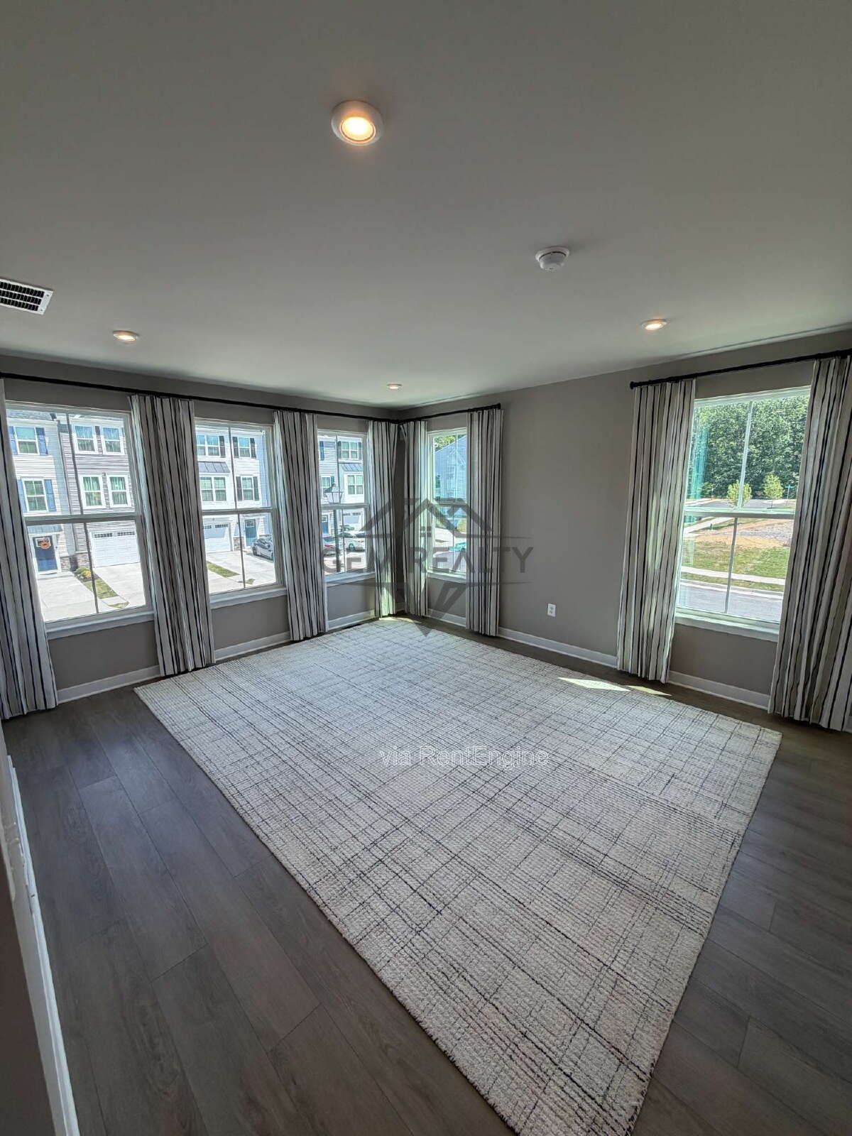 Welcome to Courthouse Commons Townhomes, where you can Rent a brand-new 3 BR 2.5 BA end unit townhome with a one-car garage and a spacious, open-concept floor plan designed for modern living. property image