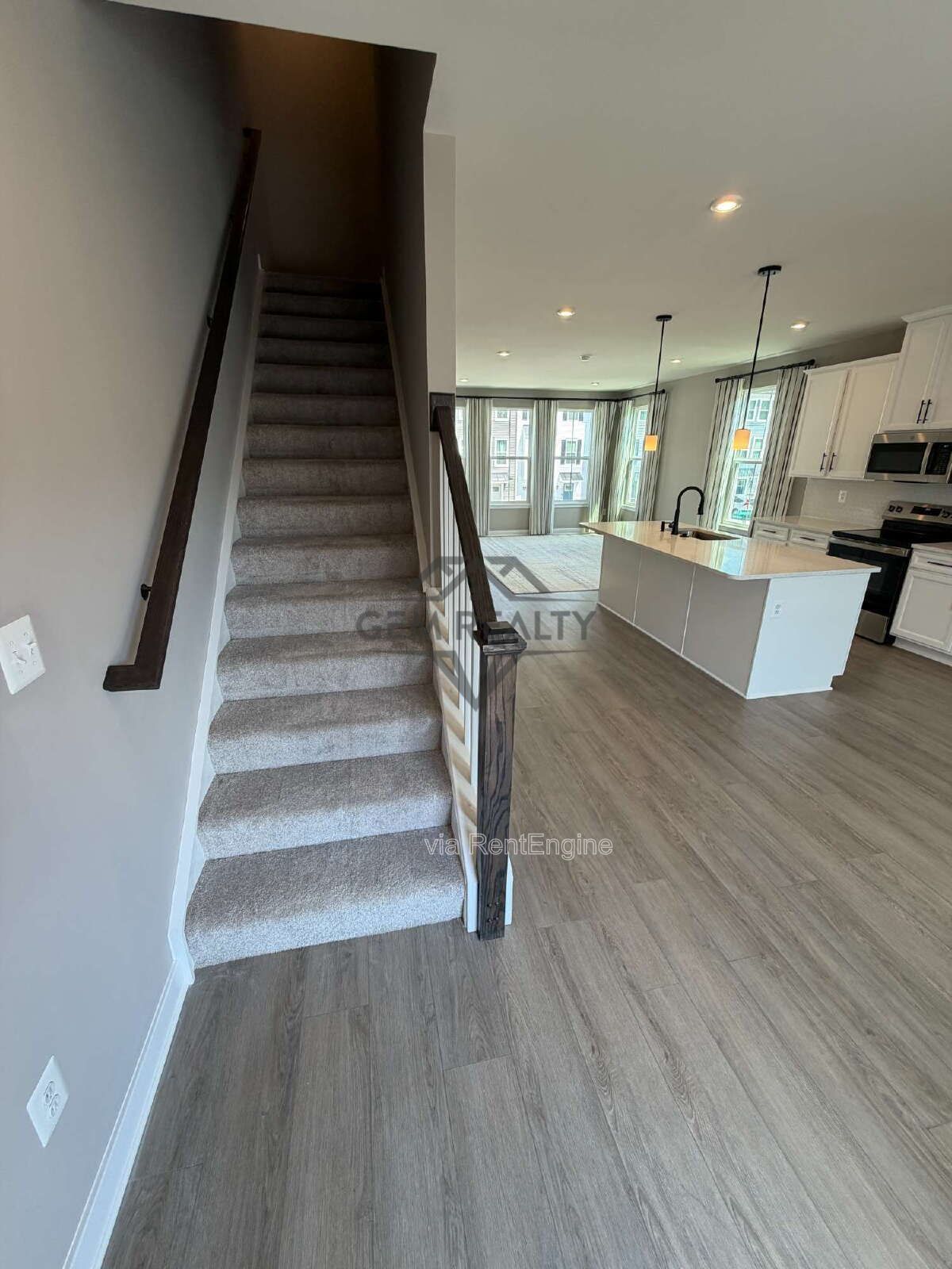 Welcome to Courthouse Commons Townhomes, where you can Rent a brand-new 3 BR 2.5 BA end unit townhome with a one-car garage and a spacious, open-concept floor plan designed for modern living. property image
