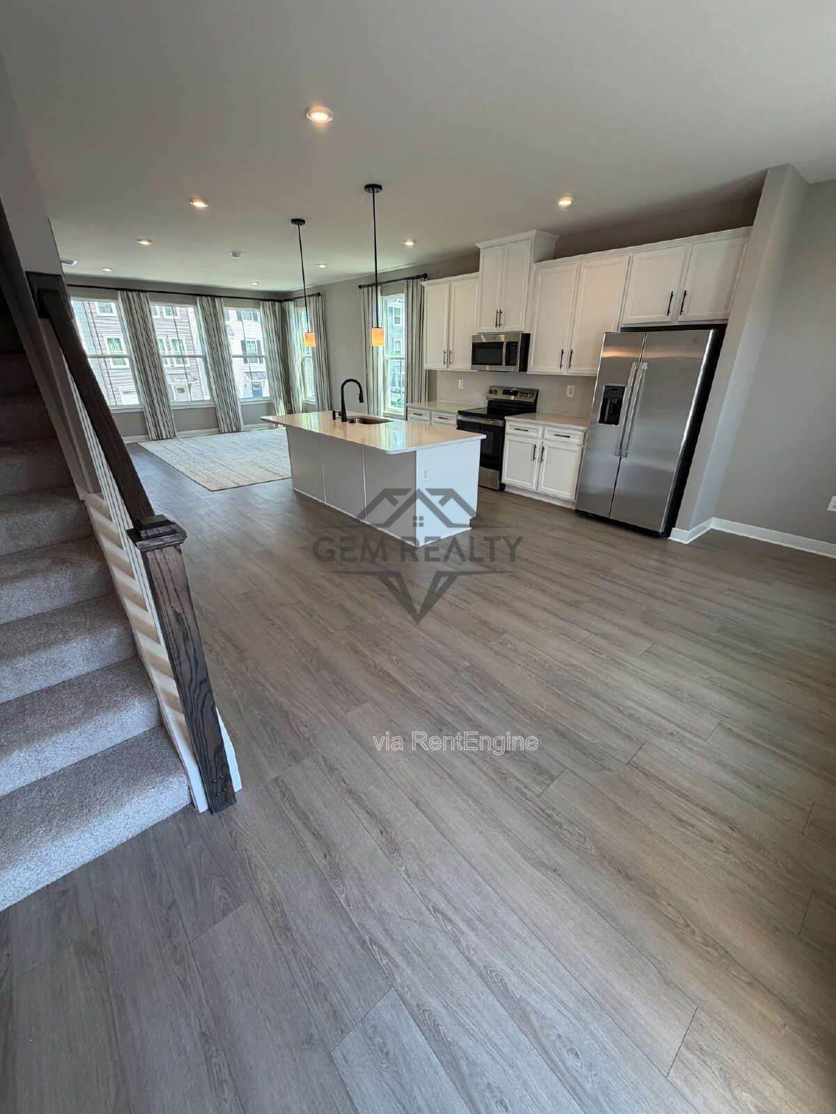 Welcome to Courthouse Commons Townhomes, where you can Rent a brand-new 3 BR 2.5 BA end unit townhome with a one-car garage and a spacious, open-concept floor plan designed for modern living. property image