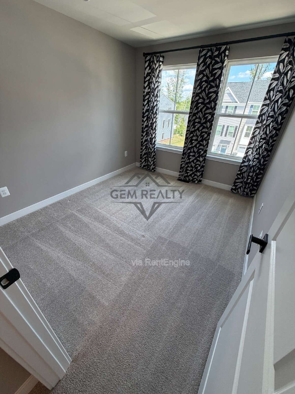 Welcome to Courthouse Commons Townhomes, where you can Rent a brand-new 3 BR 2.5 BA end unit townhome with a one-car garage and a spacious, open-concept floor plan designed for modern living. property image