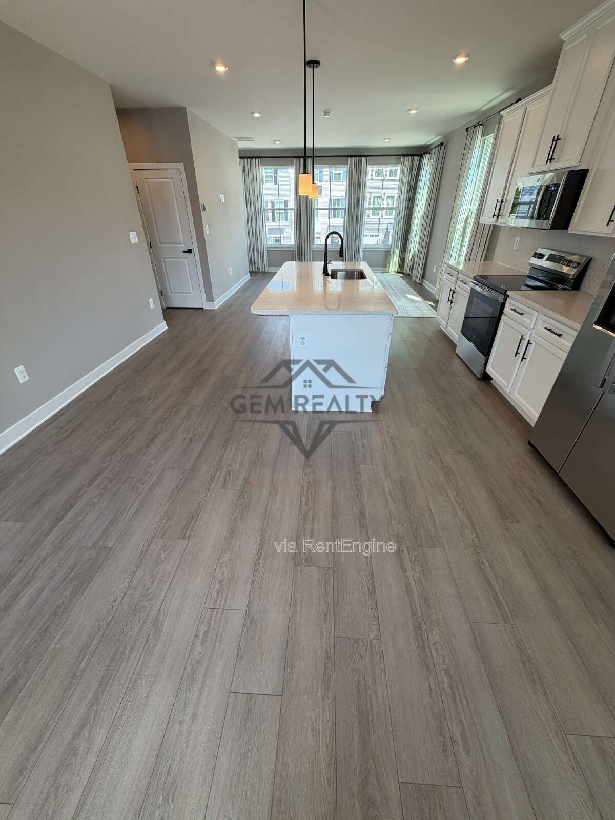 Welcome to Courthouse Commons Townhomes, where you can Rent a brand-new 3 BR 2.5 BA end unit townhome with a one-car garage and a spacious, open-concept floor plan designed for modern living. property image