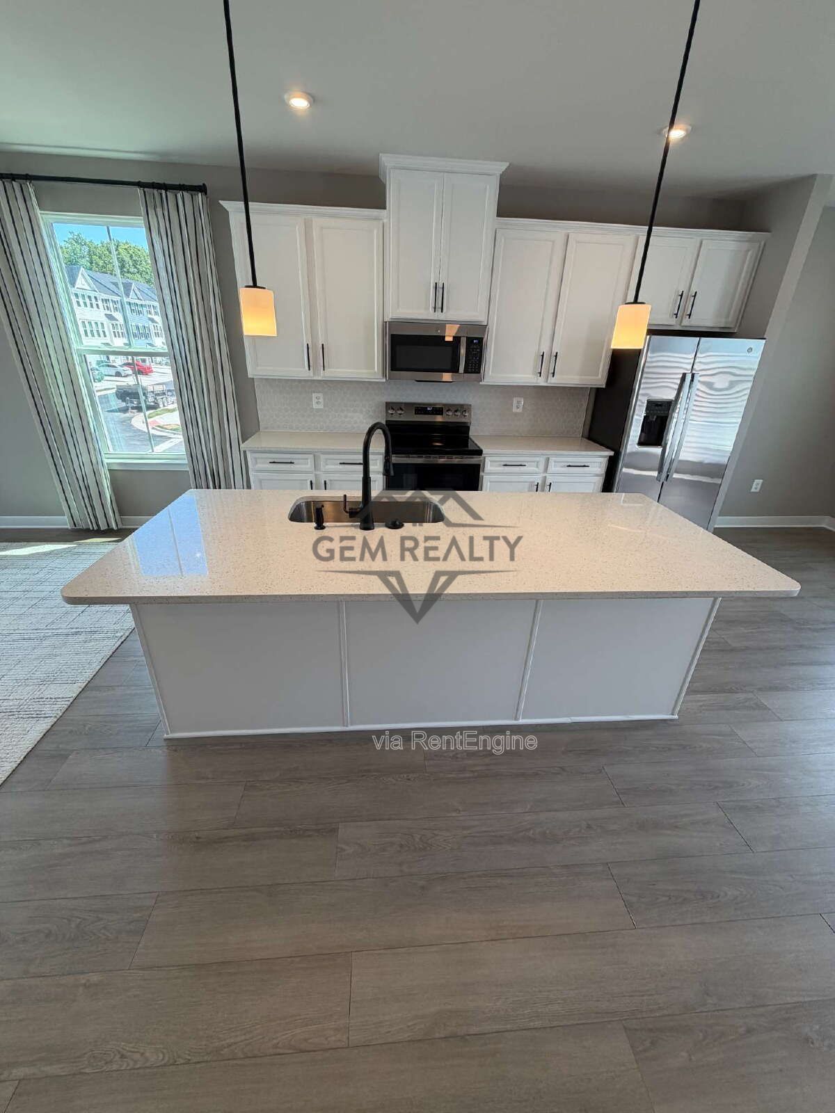 Welcome to Courthouse Commons Townhomes, where you can Rent a brand-new 3 BR 2.5 BA end unit townhome with a one-car garage and a spacious, open-concept floor plan designed for modern living. property image