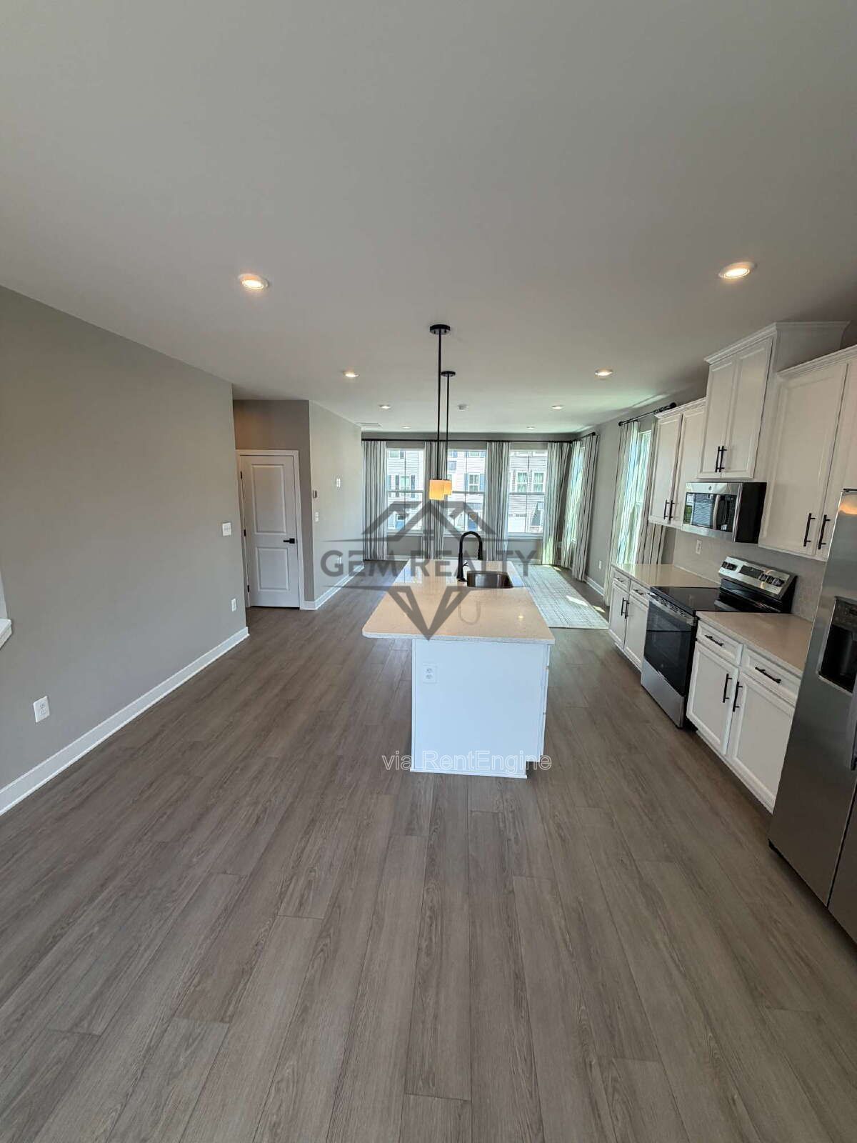 Welcome to Courthouse Commons Townhomes, where you can Rent a brand-new 3 BR 2.5 BA end unit townhome with a one-car garage and a spacious, open-concept floor plan designed for modern living. property image