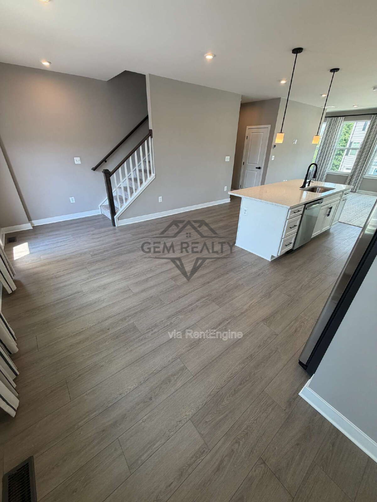 Welcome to Courthouse Commons Townhomes, where you can Rent a brand-new 3 BR 2.5 BA end unit townhome with a one-car garage and a spacious, open-concept floor plan designed for modern living. property image