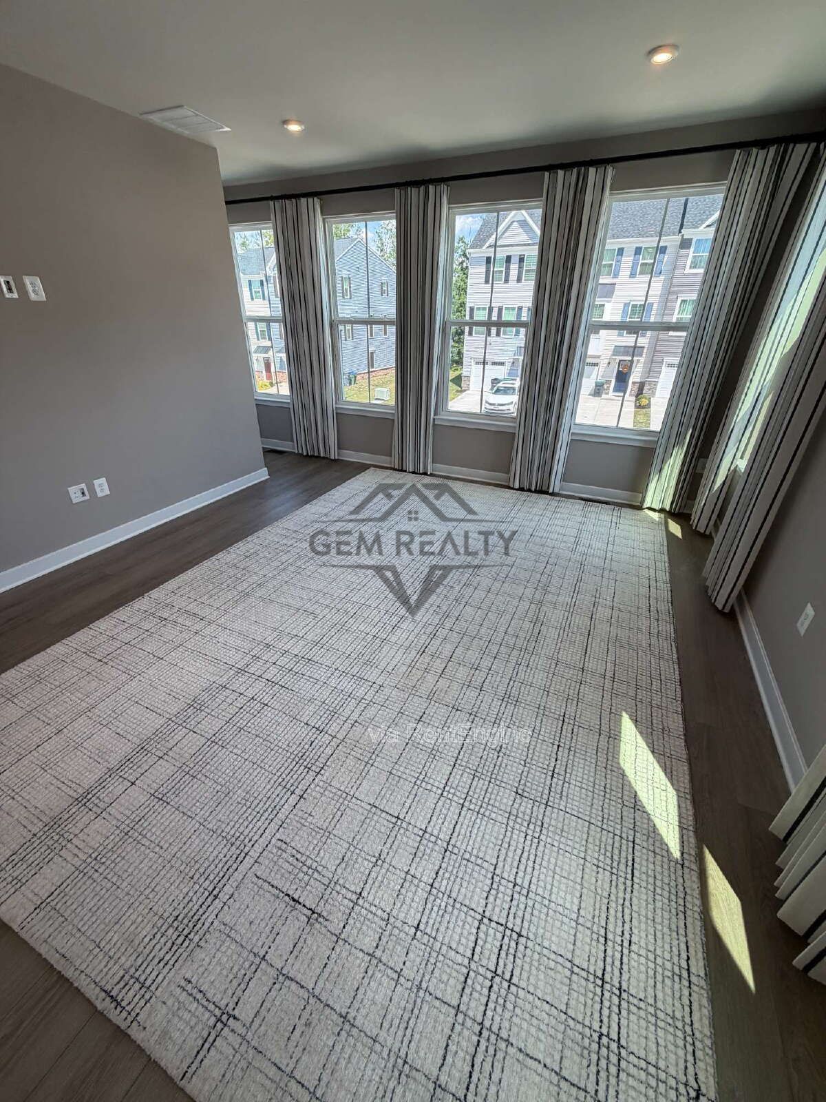 Welcome to Courthouse Commons Townhomes, where you can Rent a brand-new 3 BR 2.5 BA end unit townhome with a one-car garage and a spacious, open-concept floor plan designed for modern living. property image