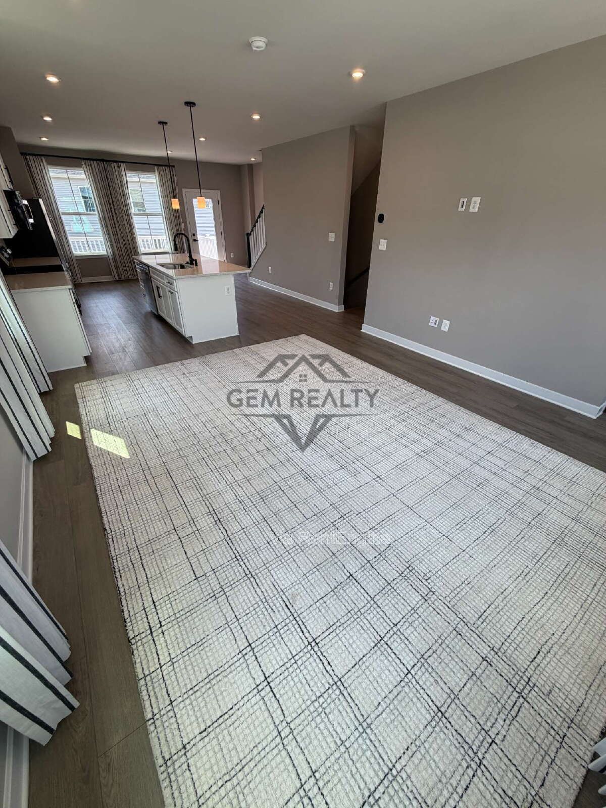 Welcome to Courthouse Commons Townhomes, where you can Rent a brand-new 3 BR 2.5 BA end unit townhome with a one-car garage and a spacious, open-concept floor plan designed for modern living. property image