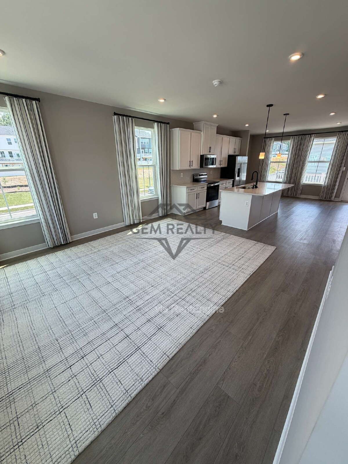 Welcome to Courthouse Commons Townhomes, where you can Rent a brand-new 3 BR 2.5 BA end unit townhome with a one-car garage and a spacious, open-concept floor plan designed for modern living. property image