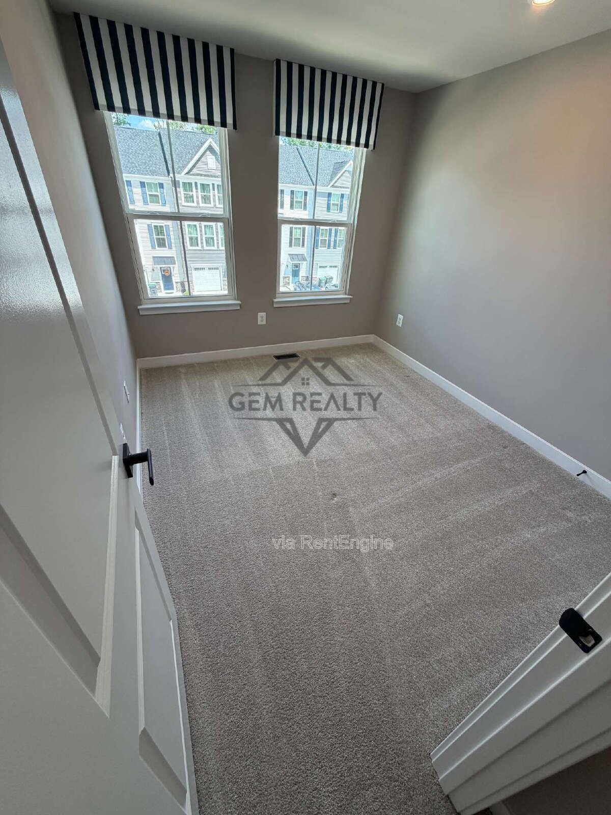 Welcome to Courthouse Commons Townhomes, where you can Rent a brand-new 3 BR 2.5 BA end unit townhome with a one-car garage and a spacious, open-concept floor plan designed for modern living. property image