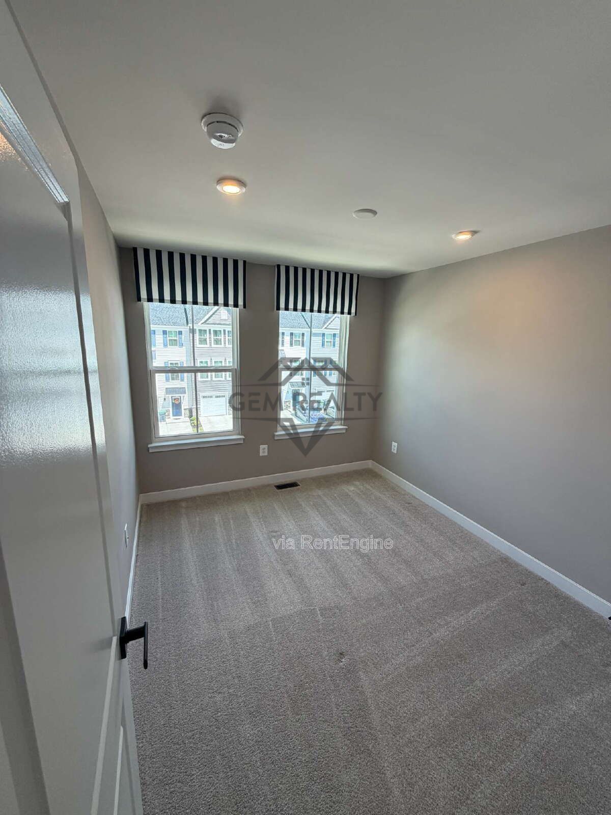 Welcome to Courthouse Commons Townhomes, where you can Rent a brand-new 3 BR 2.5 BA end unit townhome with a one-car garage and a spacious, open-concept floor plan designed for modern living. property image