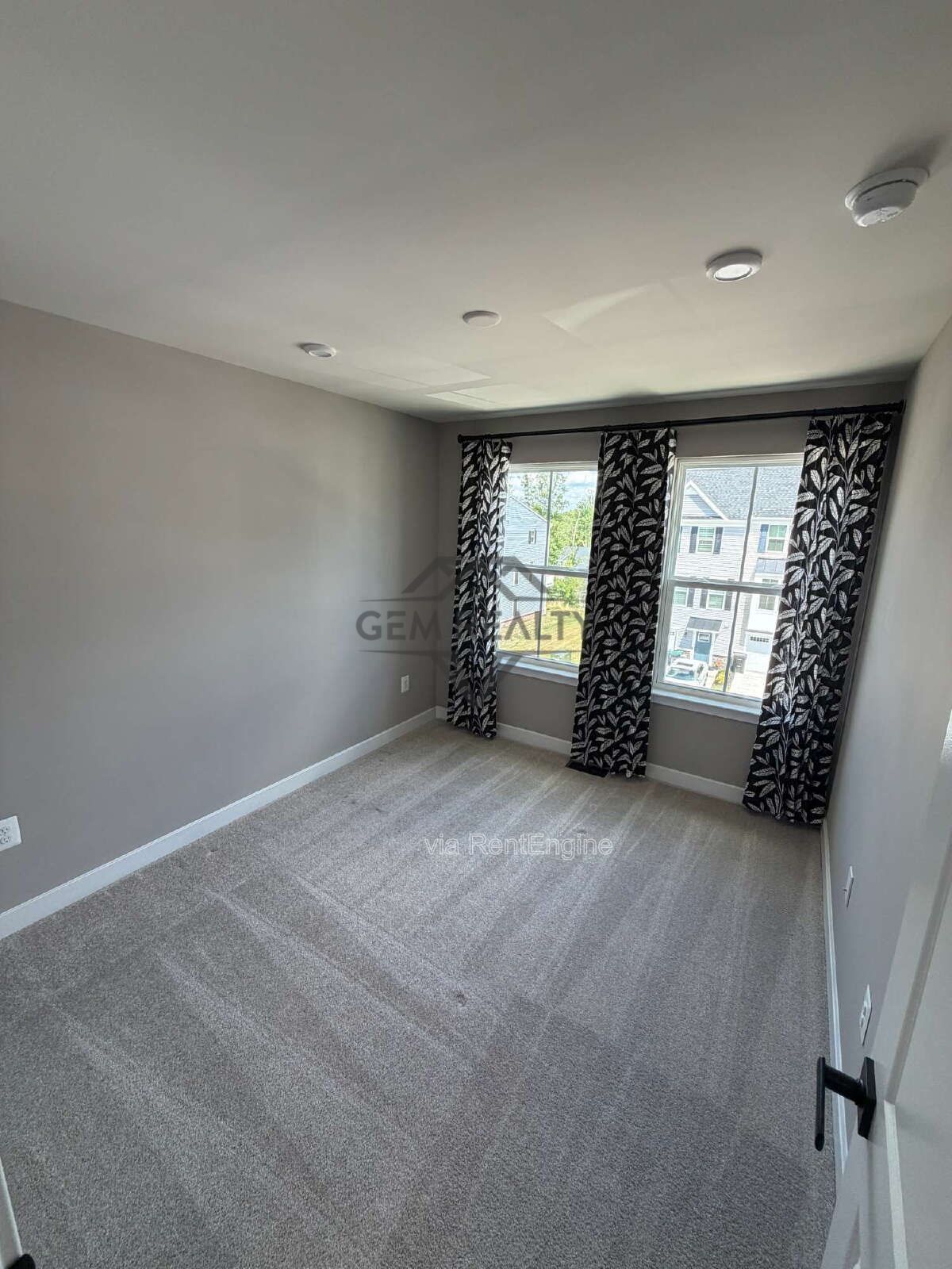 Welcome to Courthouse Commons Townhomes, where you can Rent a brand-new 3 BR 2.5 BA end unit townhome with a one-car garage and a spacious, open-concept floor plan designed for modern living. property image