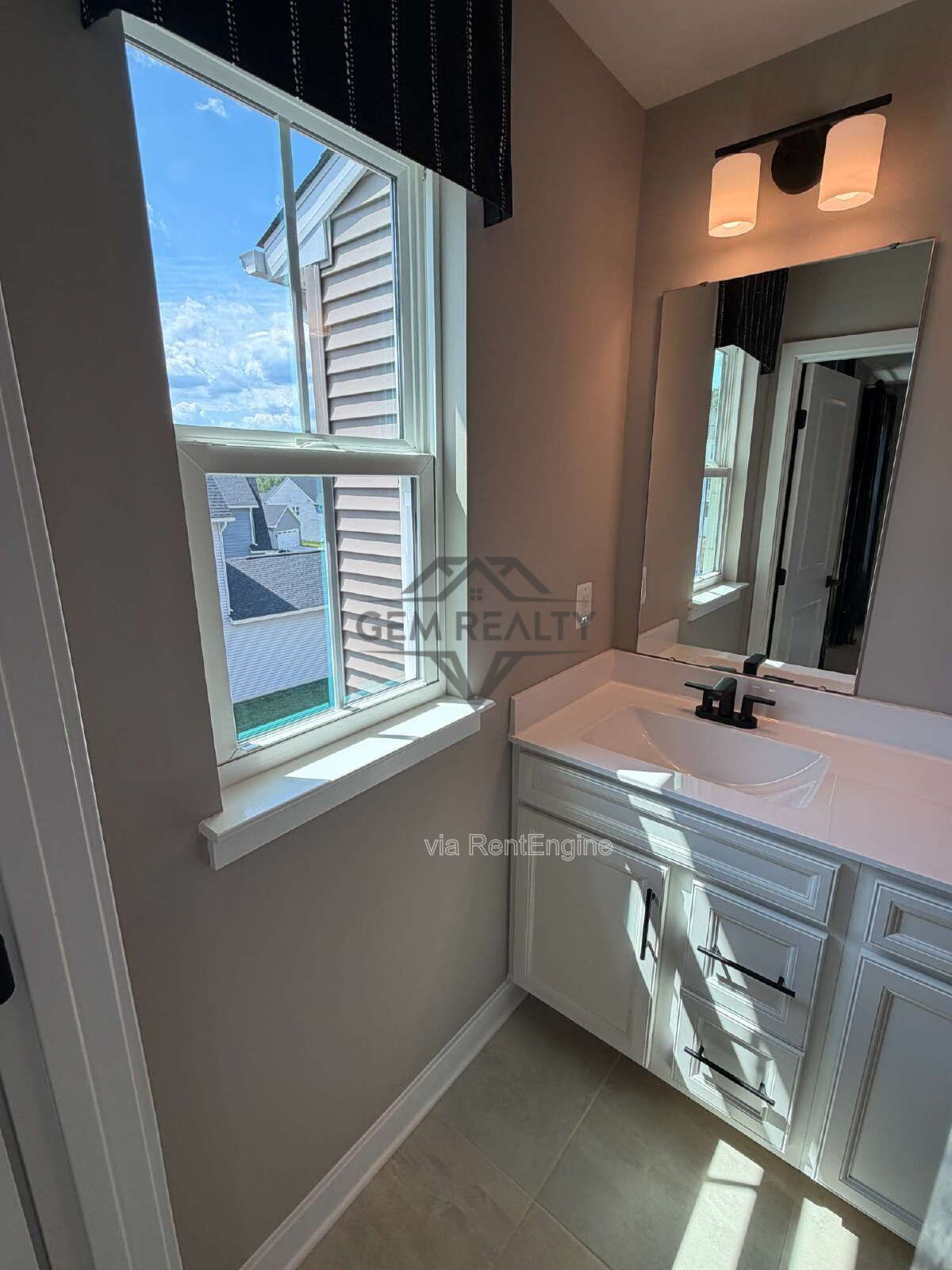Welcome to Courthouse Commons Townhomes, where you can Rent a brand-new 3 BR 2.5 BA end unit townhome with a one-car garage and a spacious, open-concept floor plan designed for modern living. property image