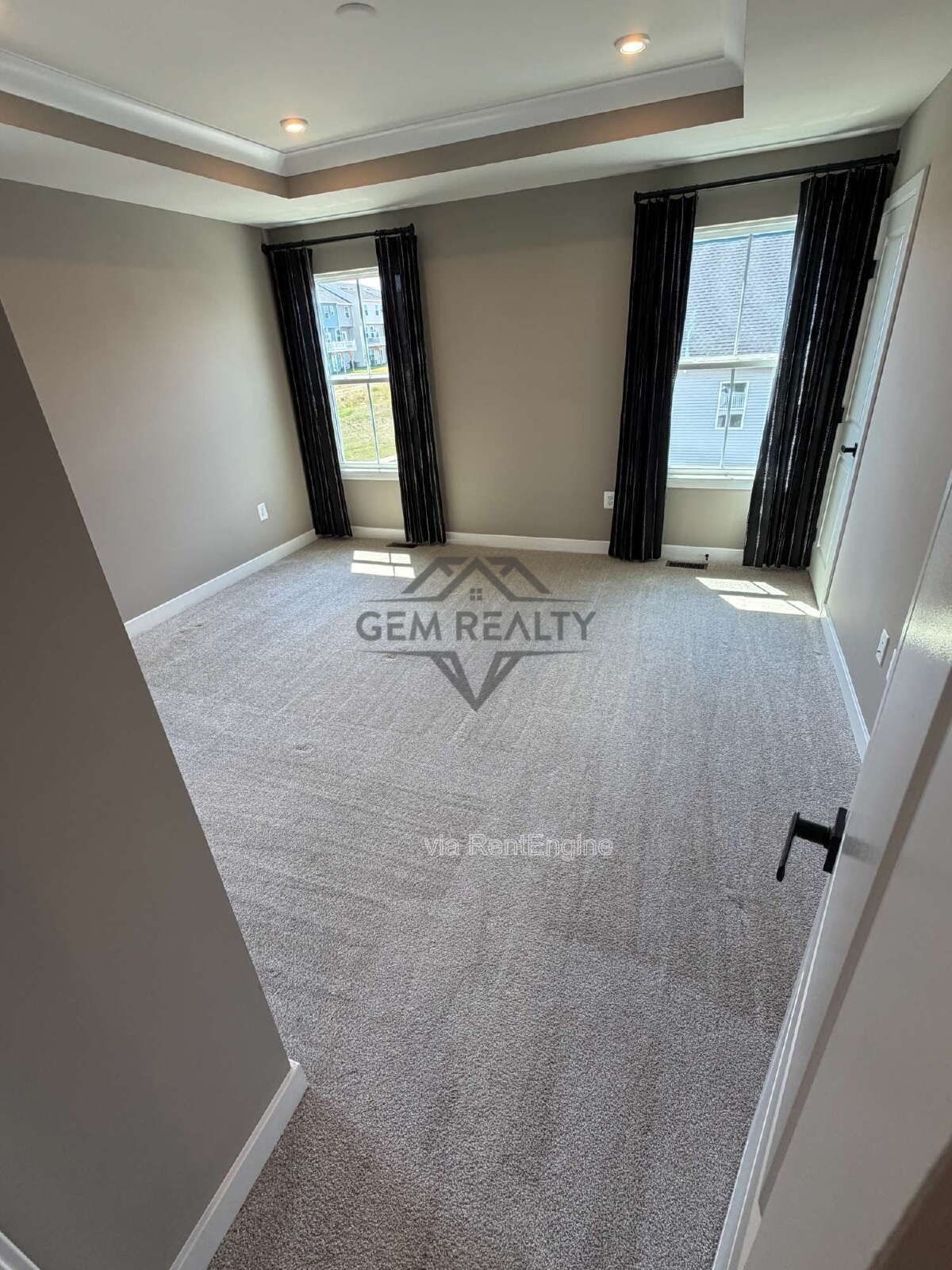 Welcome to Courthouse Commons Townhomes, where you can Rent a brand-new 3 BR 2.5 BA end unit townhome with a one-car garage and a spacious, open-concept floor plan designed for modern living. property image