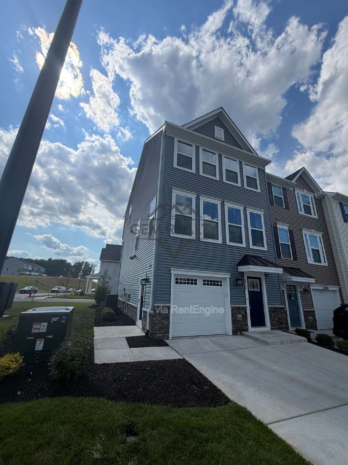 Welcome to Courthouse Commons Townhomes, where you can Rent a brand-new 3 BR 2.5 BA end unit townhome with a one-car garage and a spacious, open-concept floor plan designed for modern living. property image