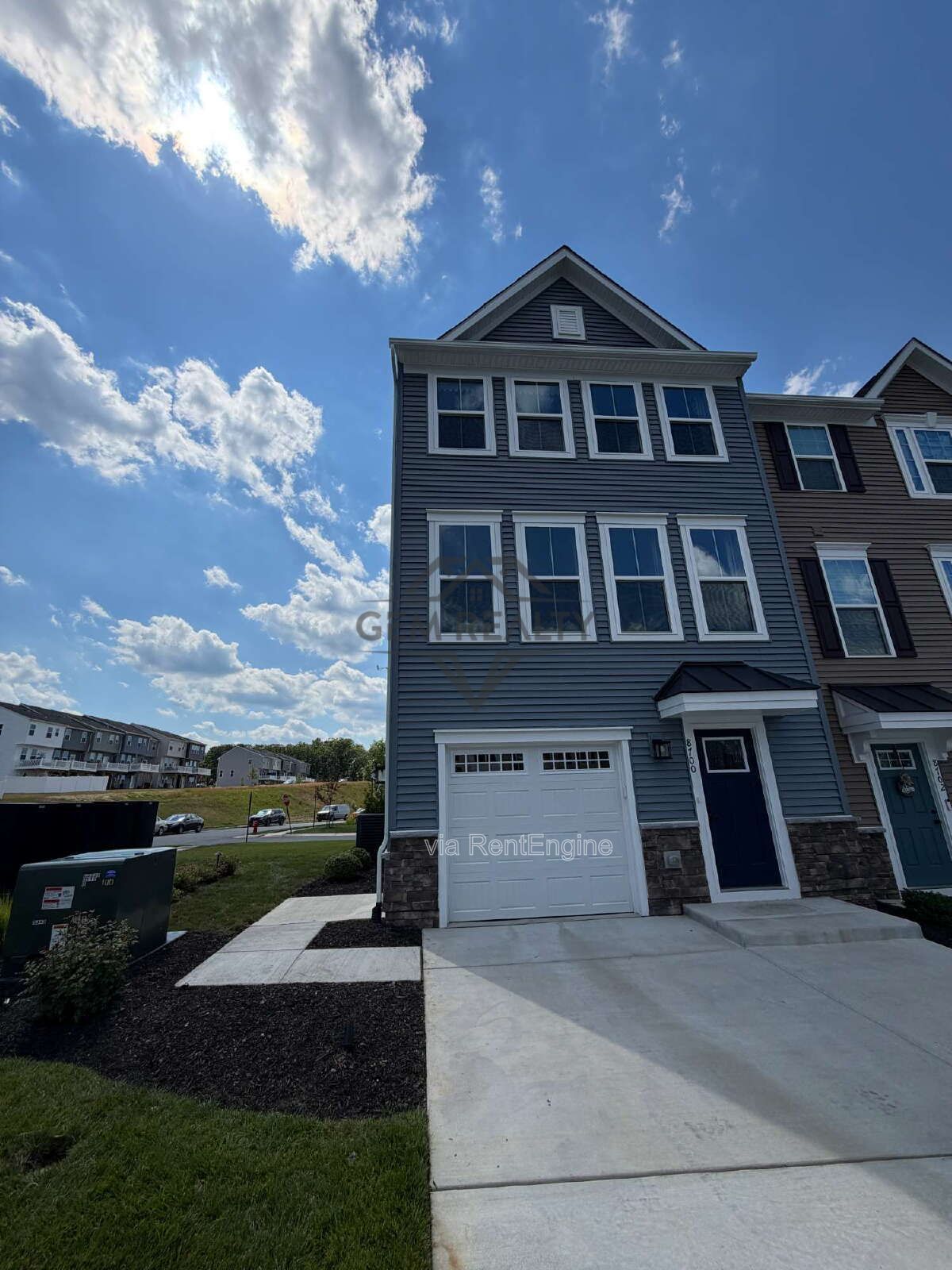 Welcome to Courthouse Commons Townhomes, where you can Rent a brand-new 3 BR 2.5 BA end unit townhome with a one-car garage and a spacious, open-concept floor plan designed for modern living. property image